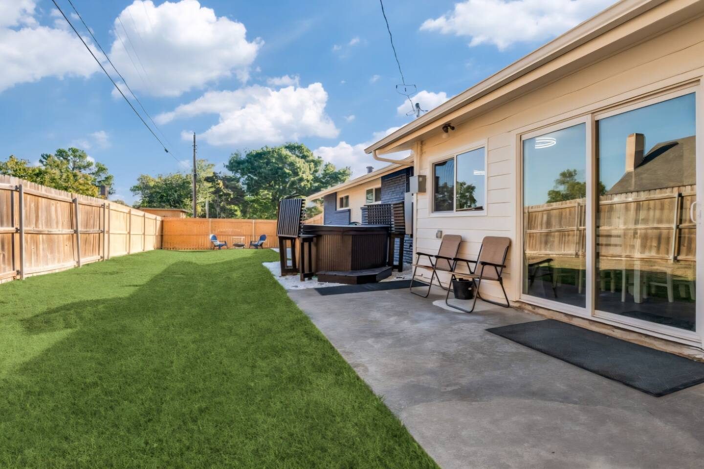 Exeter fenced backyard with turf lawn and patio